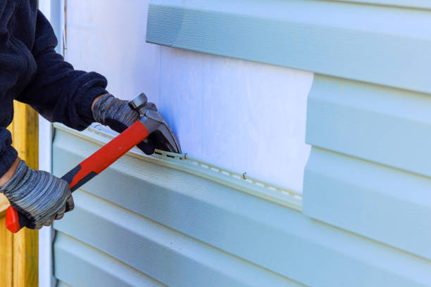 Professional vinyl siding replacement with hammer and gloves in action