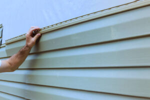 Close-up of vinyl siding being replaced on a home exterior