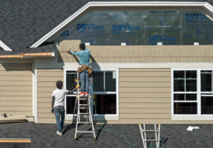 Professional contractors installing James Hardie fiber cement siding