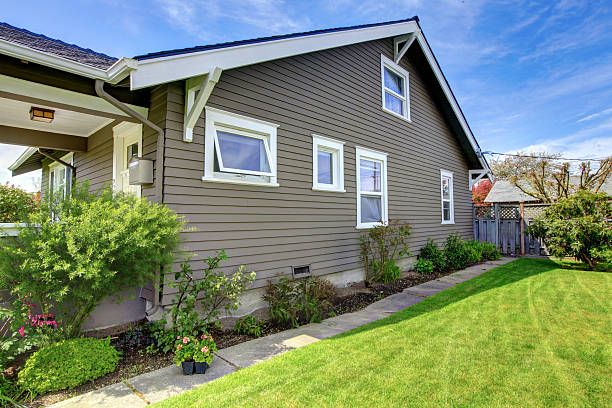 Finished exterior with newly installed siding on suburban home