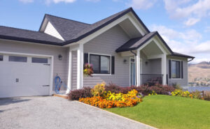 House with newly installed engineered wood siding and landscaped yard