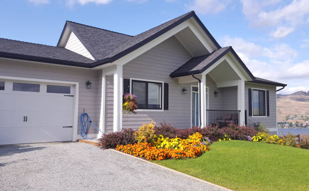 House with newly installed engineered wood siding and landscaped yard