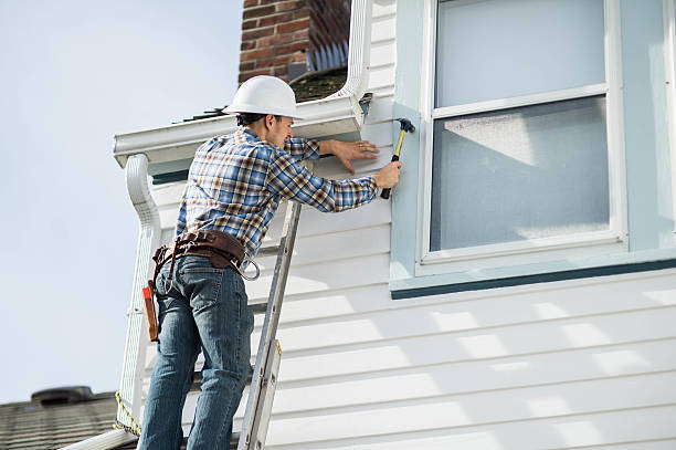 Professional applying siding to enhance home’s exterior appearance